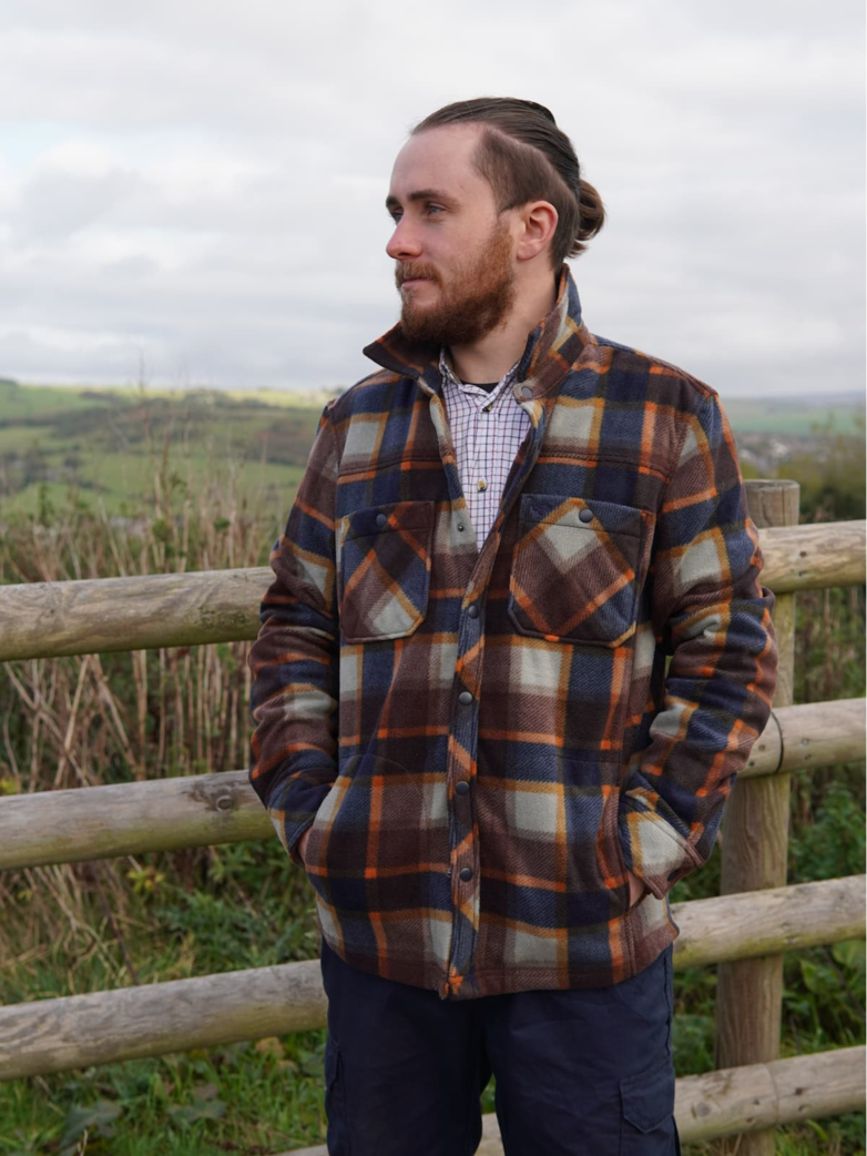 Robert Holland in a orange and dark blue check jacket.